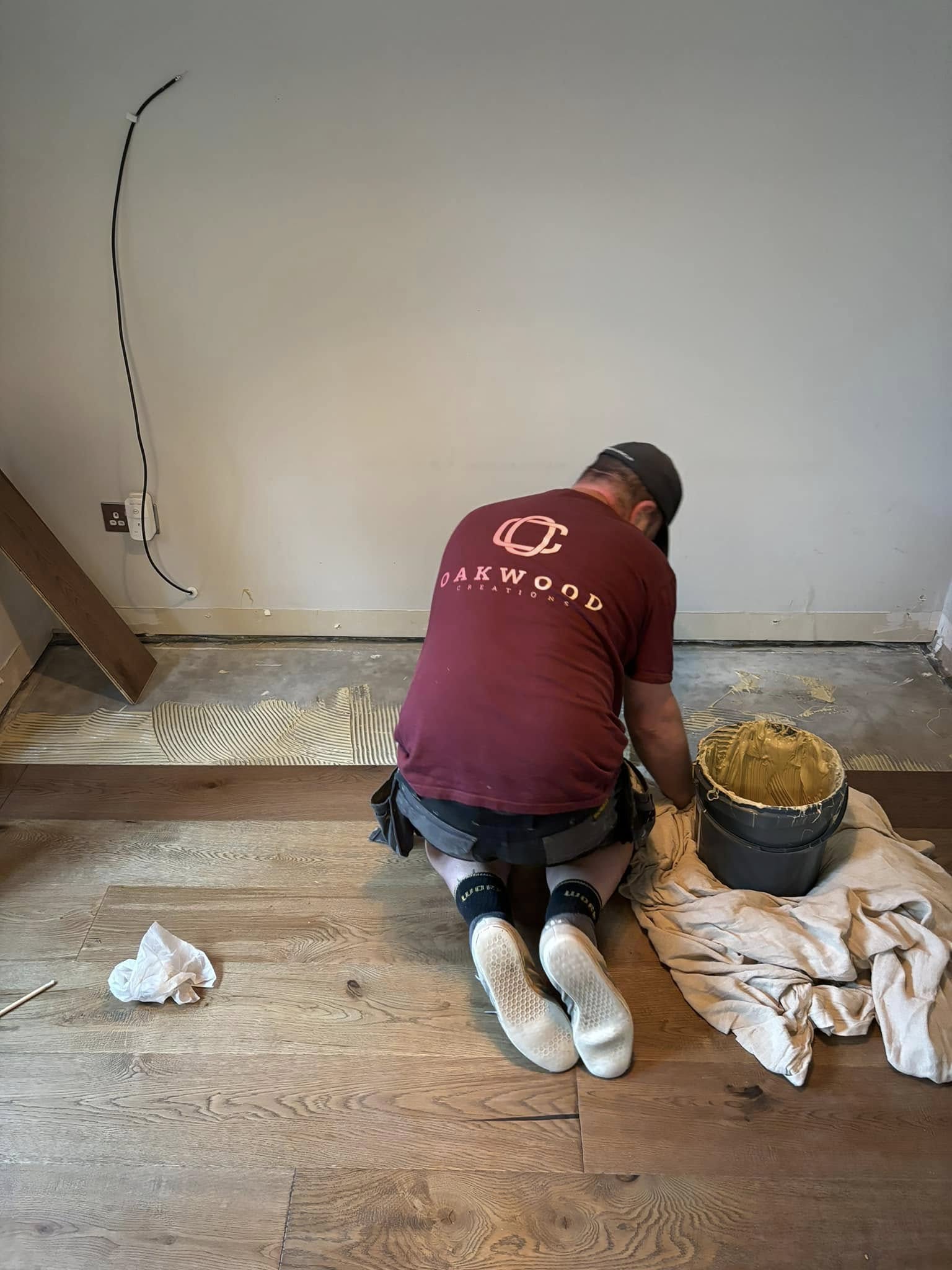 Oakwood Creations craftsman laying flooring